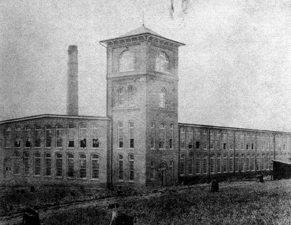 grainy black and white photograph of the mill building