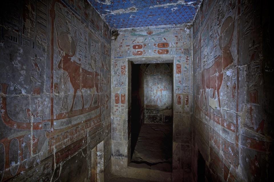 A hallway with paintings on the walls

Description automatically generated