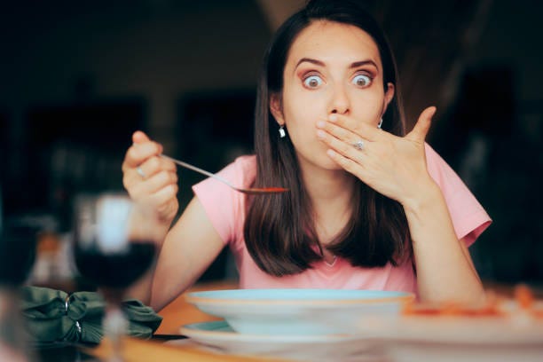 Sick Woman Eating Soup in a Restaurant Feeling Nauseated Lady feeling unwell after overeating in a diner eating surprised stock pictures, royalty-free photos & images