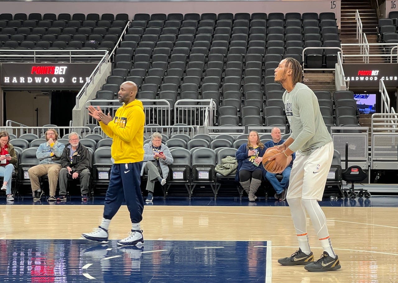 Pacers center Myles Turner warms up with coach Lloyd Pierce before playing the Bucks.