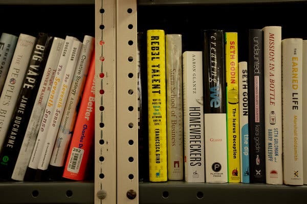 Dr. Gino’s book, “Rebel Talent: Why It Pays to Break the Rules at Work and in Life,” is among a row of books on a bookshelf.