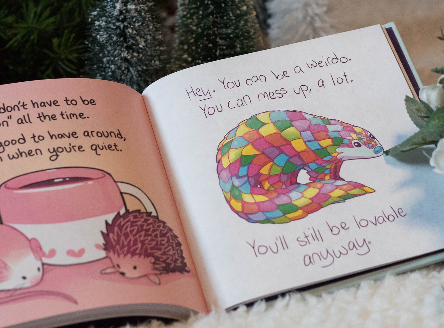 Drawing of a rainbow armadillo with text that reads Hey. You can be a weirdo. You can mess up, a lot. You'll still be lovable anyway.