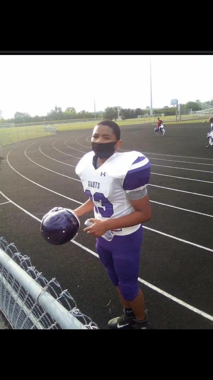 Jeremiah Lewis, at 13 years old, is pictured at a football game.