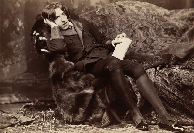 sepia photo of Oscar Wilde reclining on a divan