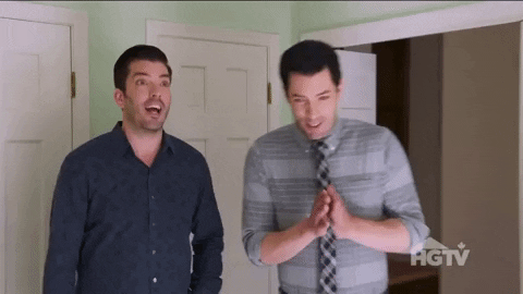 The Property Brothers dancing excitedly and clapping their hands together