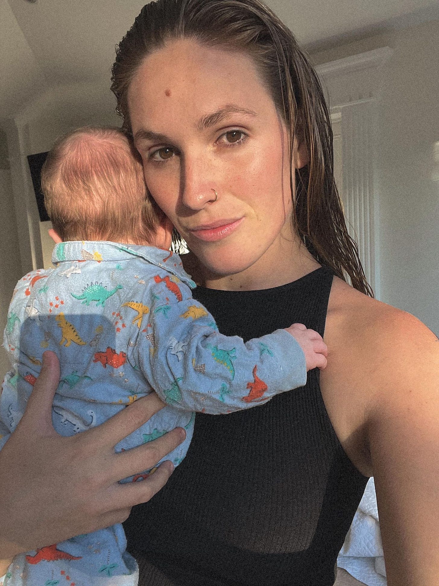 A selfie of Kat River holding her baby