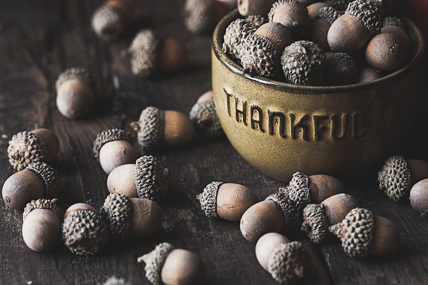A bowl of acorns with the word "Thankful" written on it