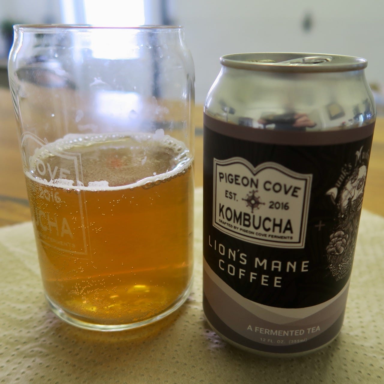 A can of kombucha and a glass of beer

Description automatically generated