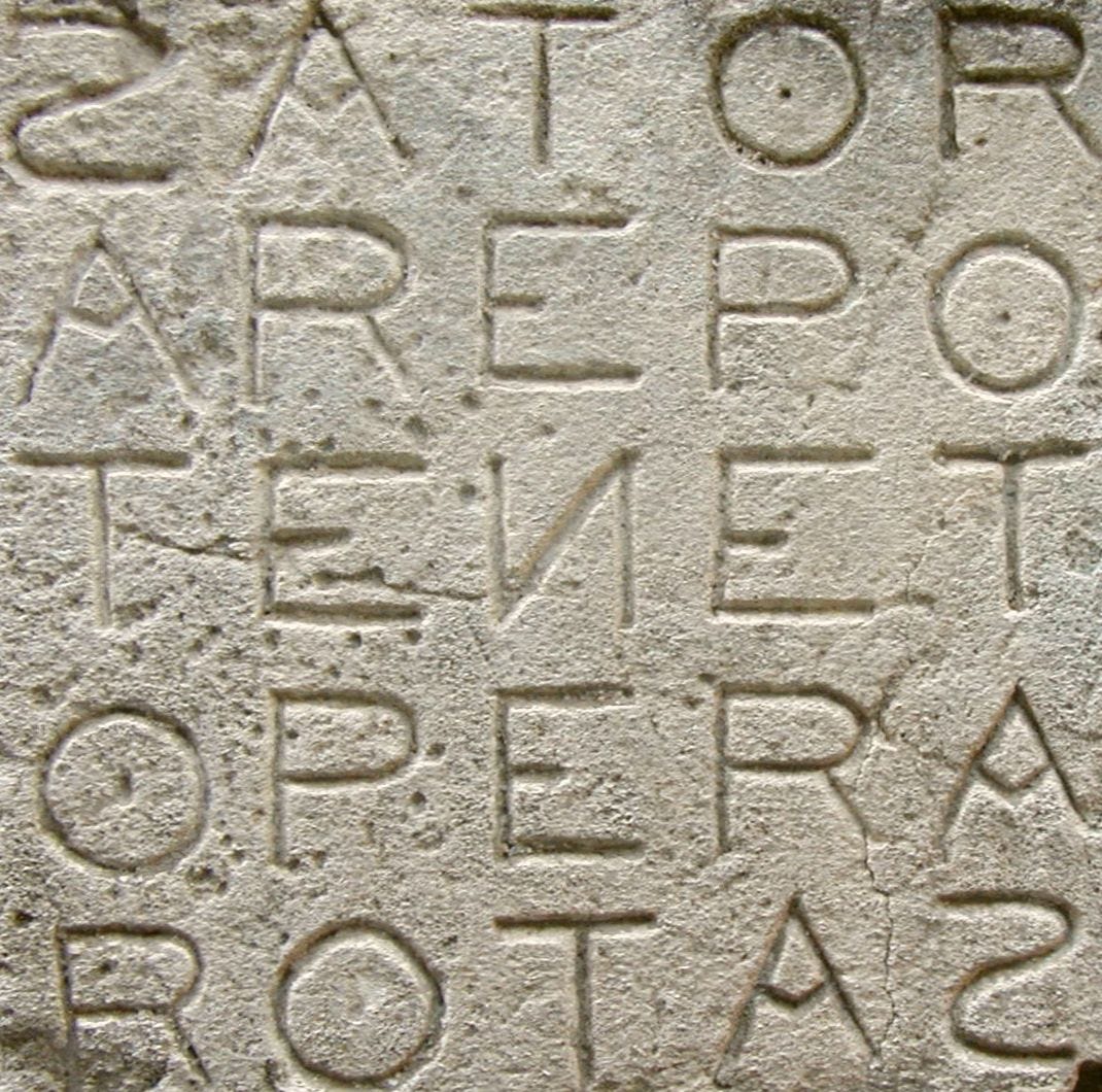 Five five-letter Latin words arranged in a grid so that each word can be read both across and down. The Sator Square is carved into a stone wall.