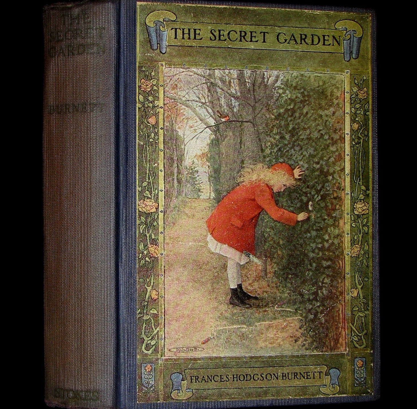 An old book of The Secret Garden by Franes Hodgson Burnett. In antique green and with an illustration of a blond girl bending down to a door in a wall. SHe is dressed in red