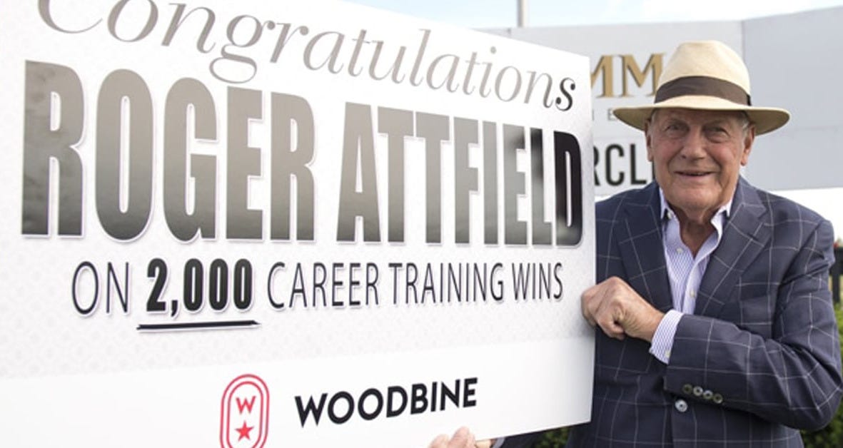 An older man holding a large sign.