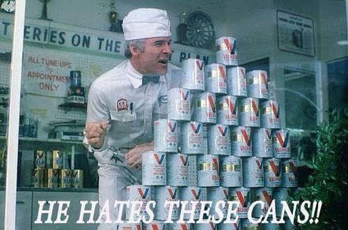 screenshot of Steve Martin in 'The Jerk,' hiding behind a stacked pyramid of oil cans. Caption reads 'He hates these cans!' 