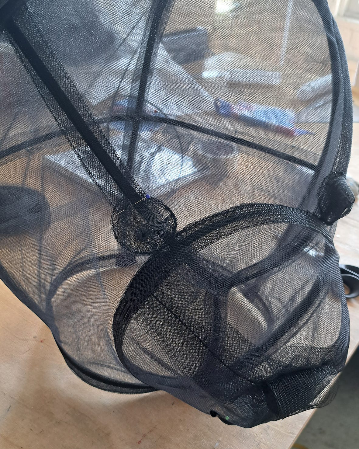 close-up of a transparent teddy bear head made of black tulle fabric