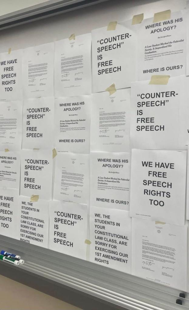 Protest signs covering Stanford Law School dean's classroom whiteboard.