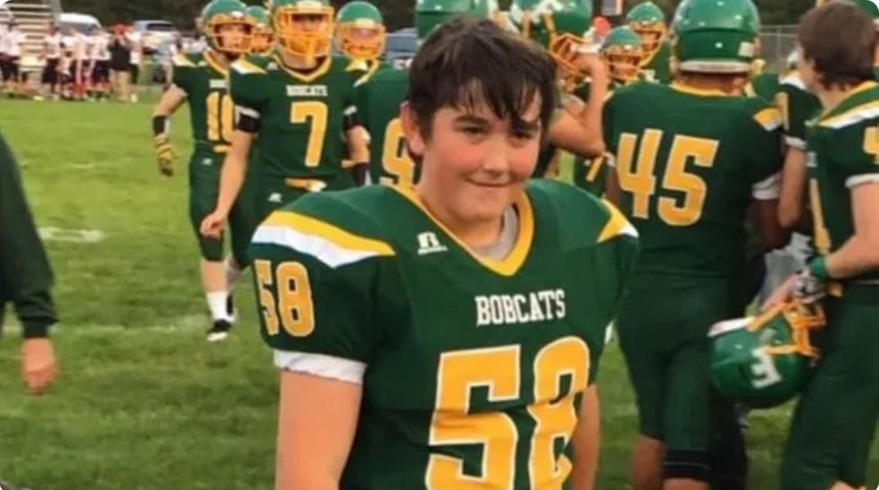 16-year-old Michael \u201cMikey\u201d Schuls in his green and yellow football uniform.