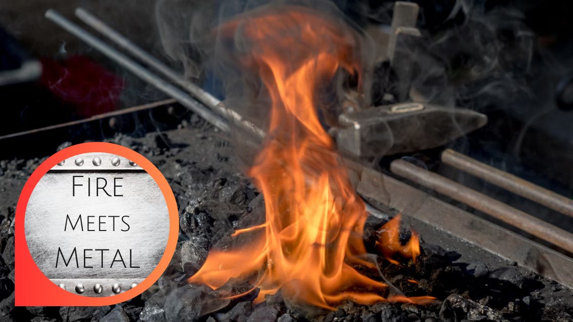 Fire meets Metal: metal instruments lay smoking within the flames of a forge.