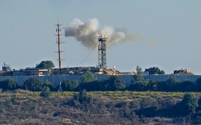 Smoke rises from inside an Israeli army position which was hit by missiles launched by the Hezbollah terror group, as seen from Tair Harfa village, a Lebanese border village with Israel, south Lebanon, October 20, 2023. (AP Photo/Hassan Ammar)