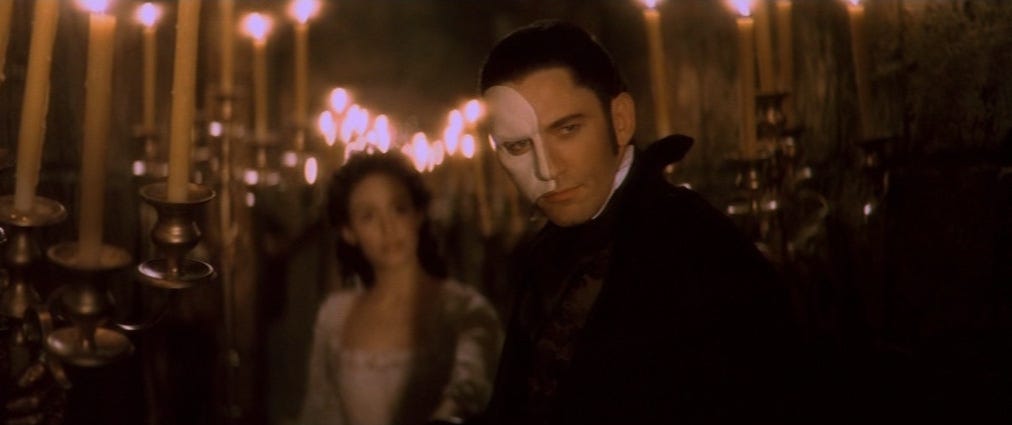 The Opera Ghost/Phantom leads Christine through the hallways (Phantom of the Opera, 2004)