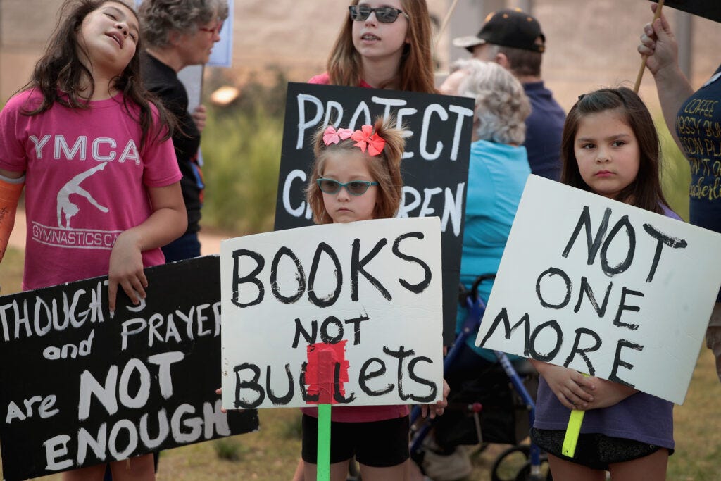 Children hold signs protesting gun violence