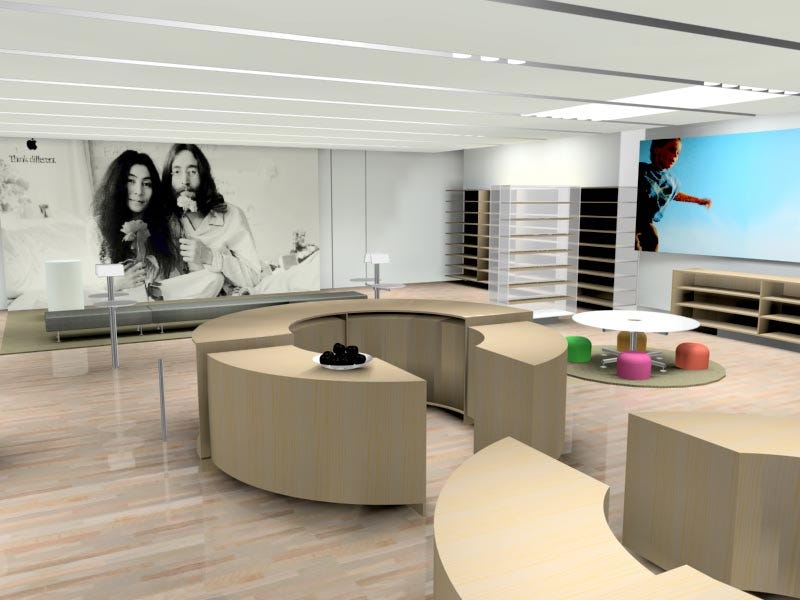 A concept rendering of the first Apple Store. The Theater is positioned at the far end of the room. A poster of John Lennon and Yoko Ono covers the wall. Gray seating sits on a brown carpet nearby.