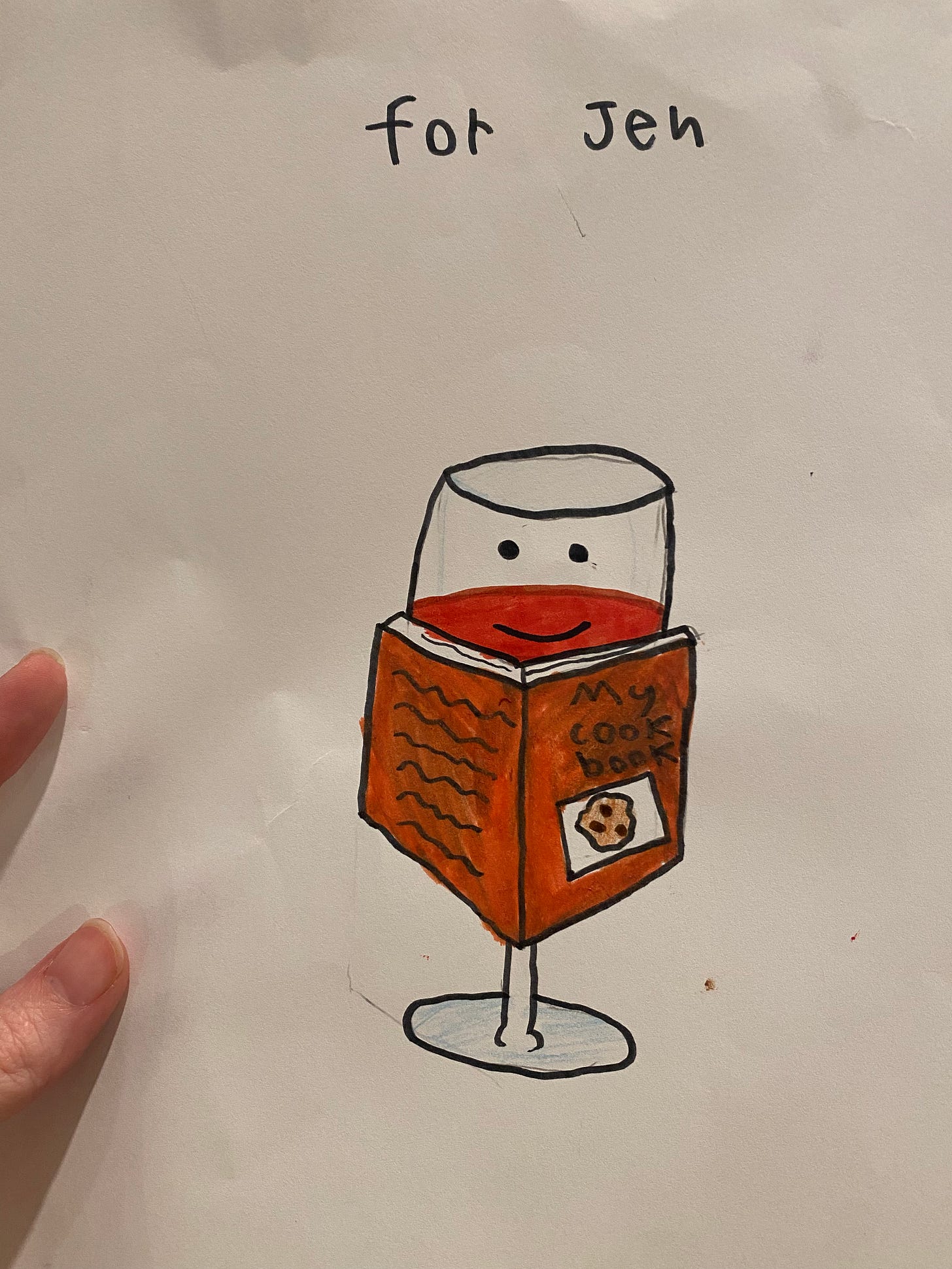 A drawing done by an older child, a glass of red wine with a smiley face, in front of a book that says 'my cookbook' on the cover. text at the top of the page reads 'for Jen'.
