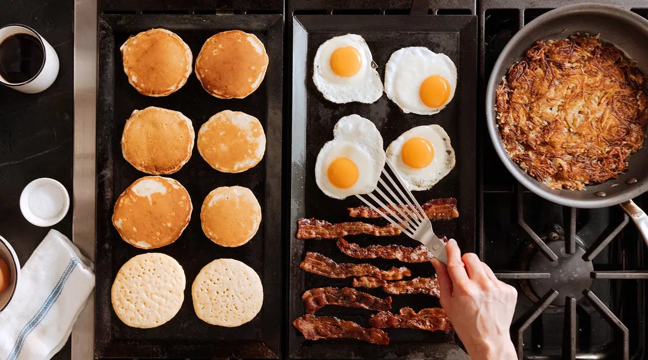 Griddle with pancakes and eggs.