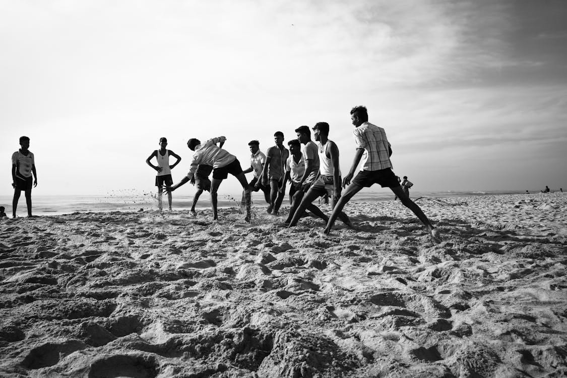 Free A group of boys playing on the sandy beach of Thiruchendur, India in a striking black and white photograph. Stock Photo