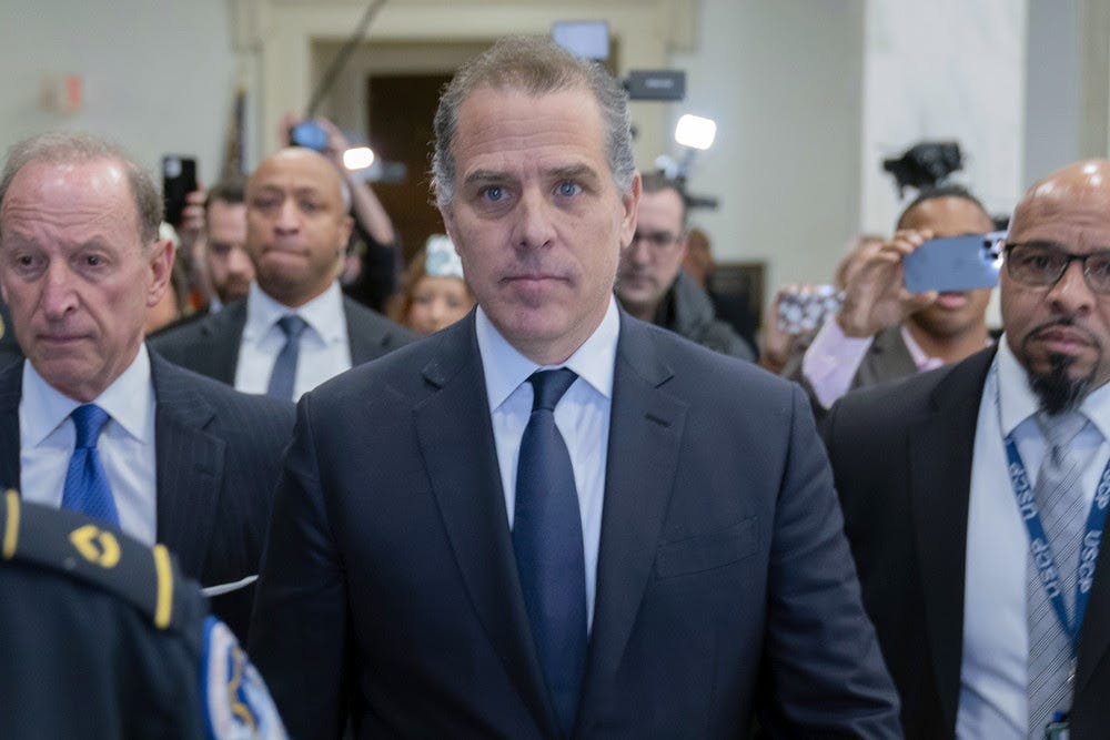 Hunter Biden, President Joe Biden's son, accompanied by his attorney Abbe Lowell, left, leaves a House Oversight Committee hearing as Republicans are taking the first step toward holding him in contempt of Congress, Wednesday, Jan. 10, 2024, on Capitol Hill in Washington. (AP Photo/Jose Luis Magana)
