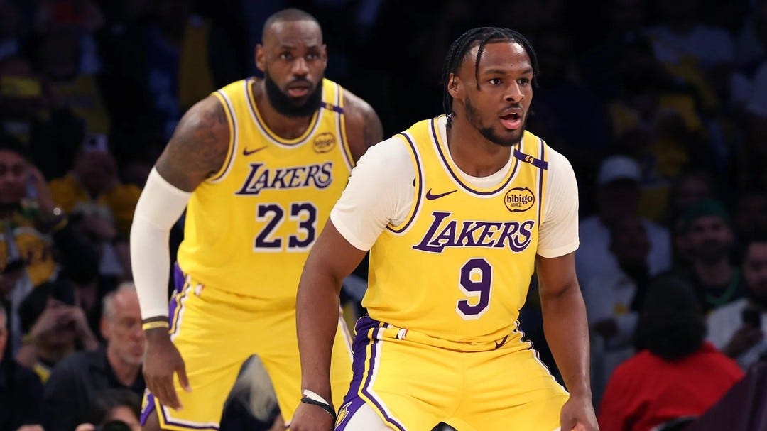 Photo by Matt Ruby on October 23, 2024. May be an image of 6 people, people playing basketball, basketball jersey, ball, backboard, crowd, basketball court and text.