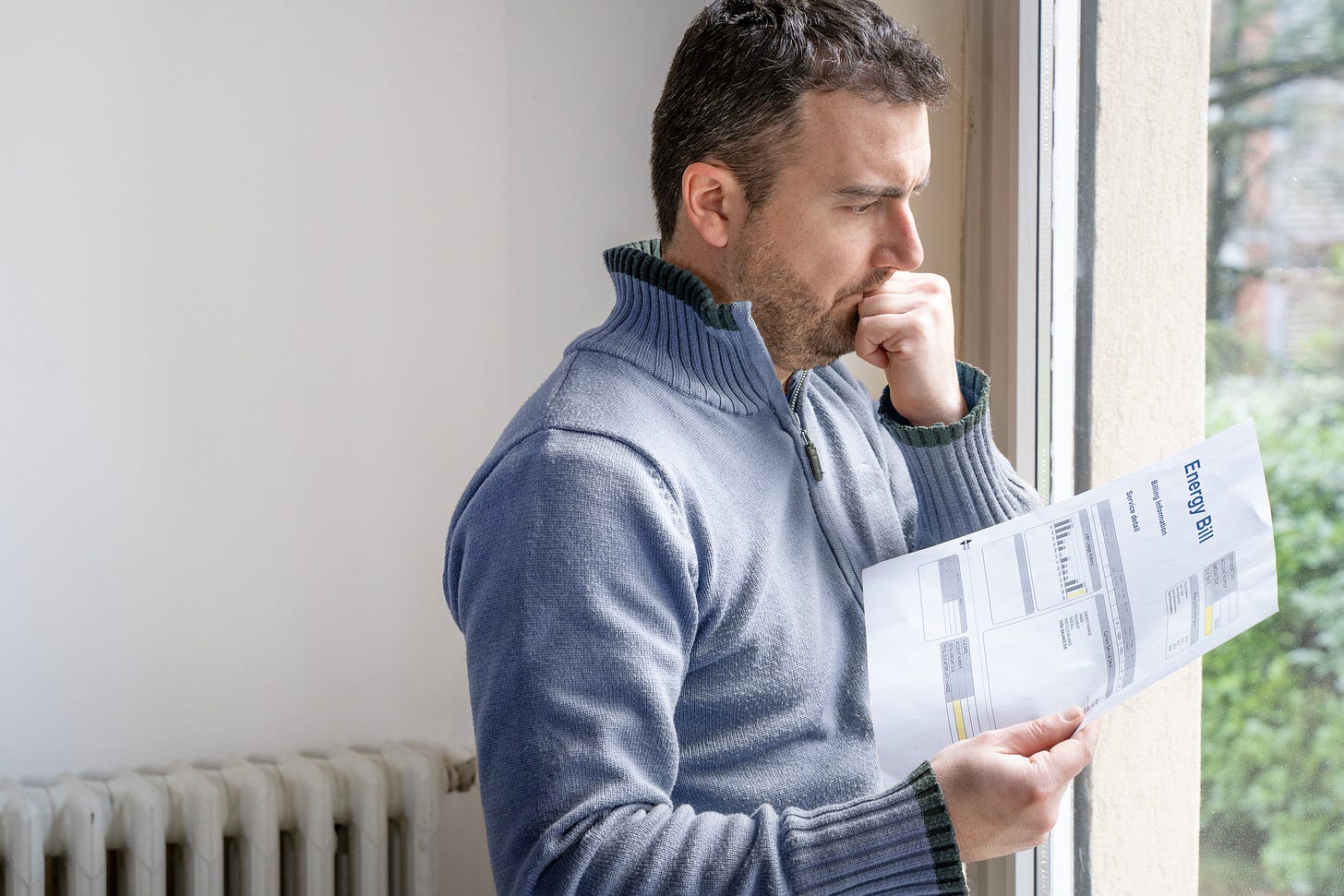 Man pondering his electricity bill