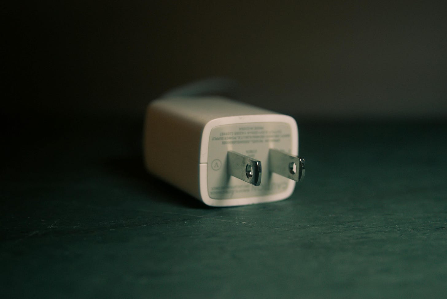 The end of a white travel adapter.