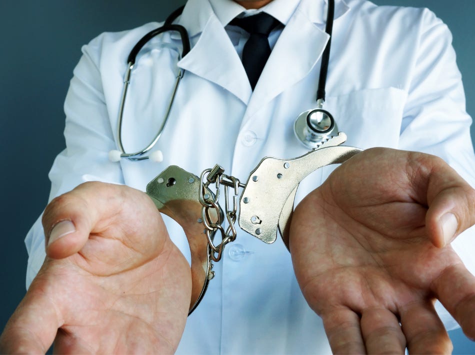 male doctor in white coat with handcuffs