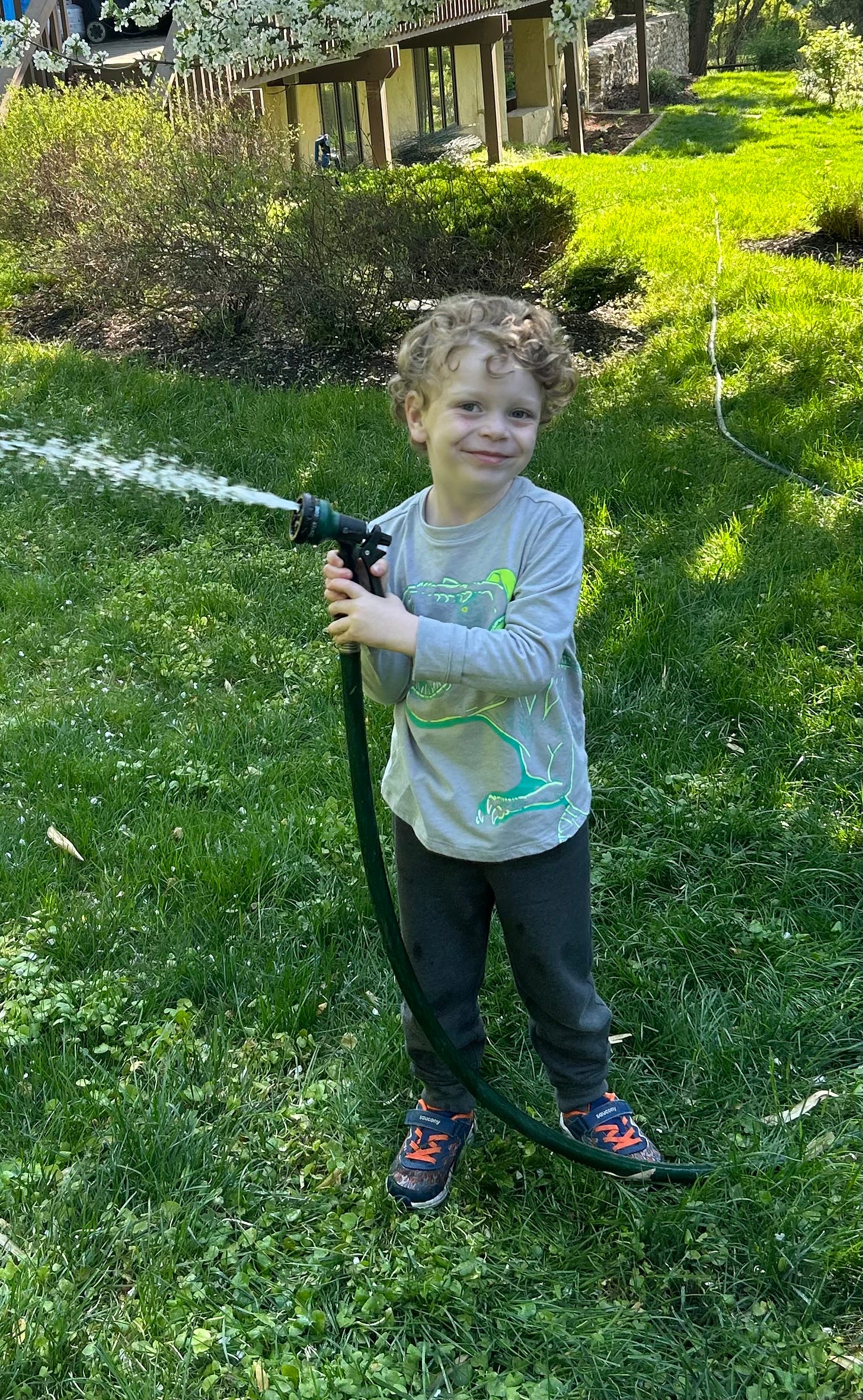 Jagger spraying a garden hose