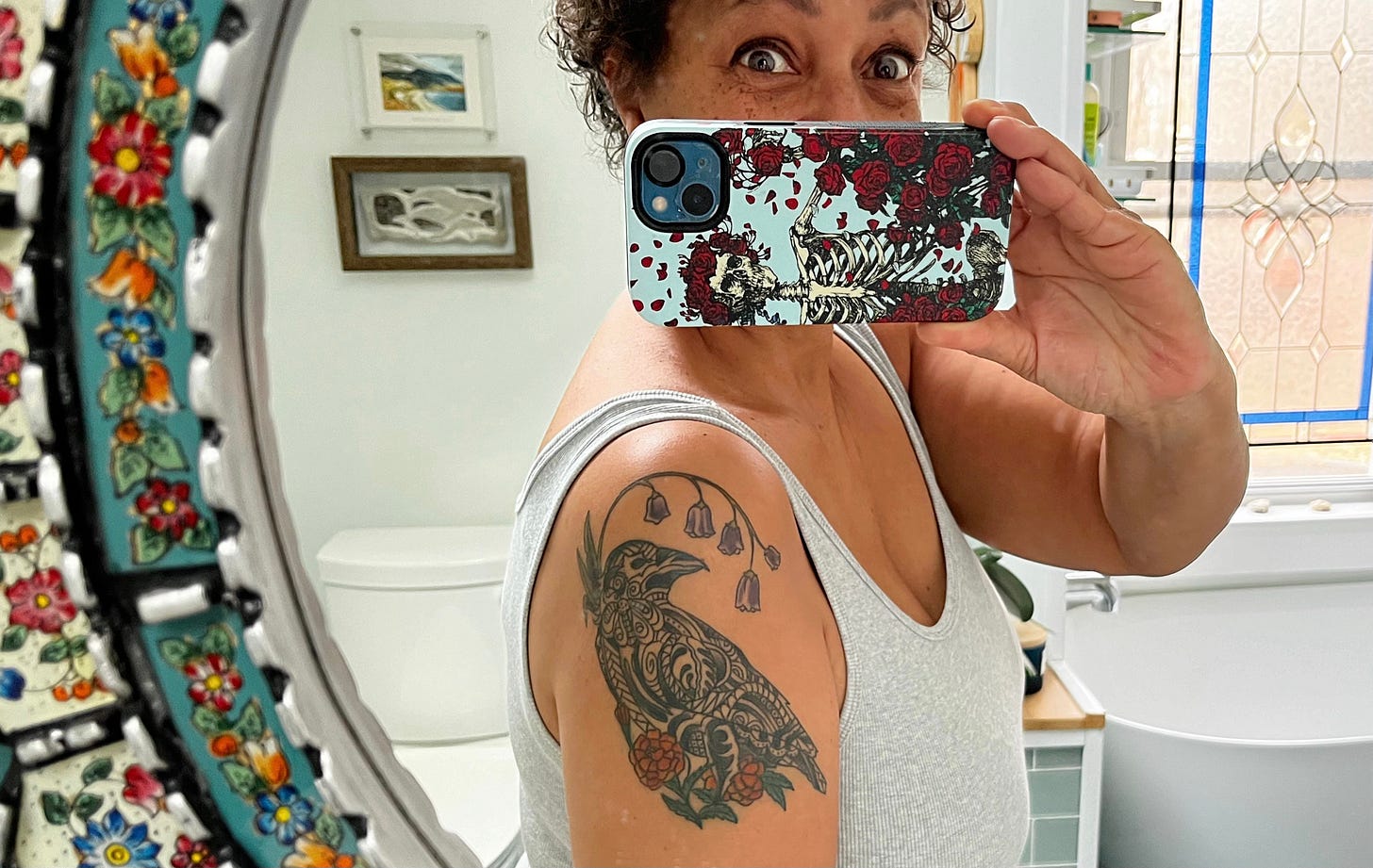 selfie taken in a bathroom mirror showing my crow tattoo 