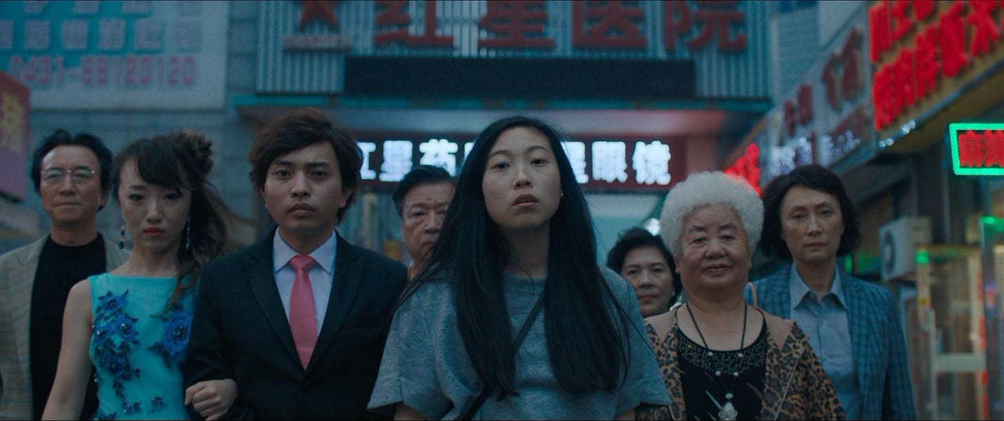 Billi and her extended family walking through the Chinese marketplace, somber in spite of the neon.