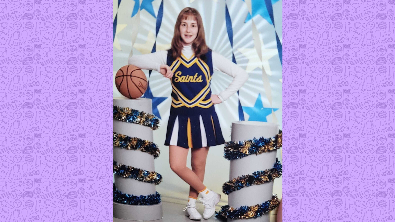 little me posing for a cheerleading photo holding a basketball