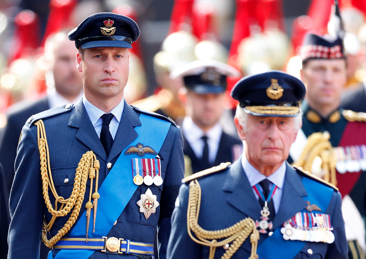 Prince William standing behind King Charles