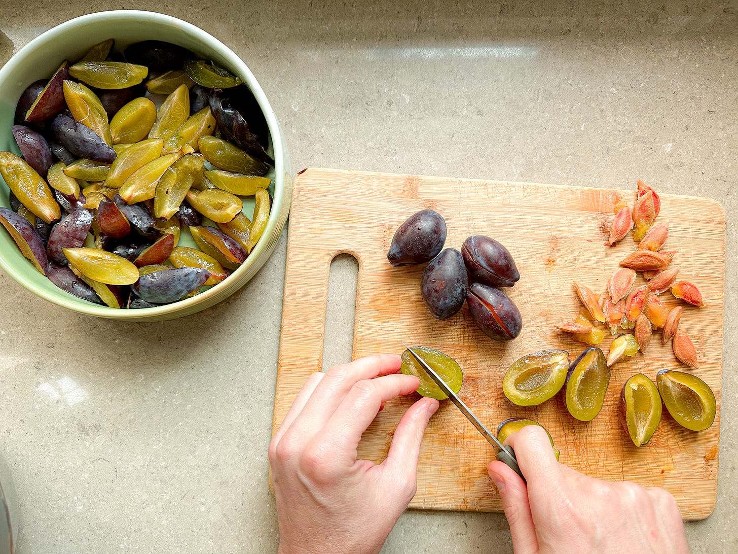 A photo of plums in a ceramic baking dish, and Martin's hands pitting and slicing plums. 