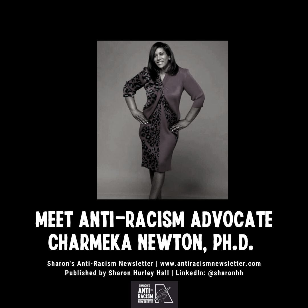 Photo of Dr Charmeka Newton wearing a dress with hands on hips. She has long hair and is smiling. Interviewed by Sharon Hurley Hall for the Anti-Racism Newsletter