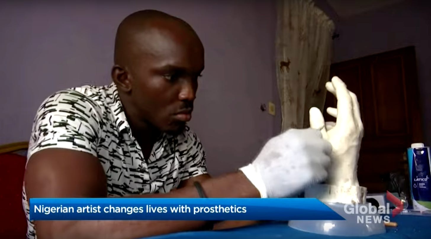 Black man sculpting a hand prosthetic