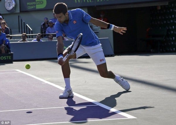 novak djokovic returning steve darcis balls for 2015 miami open masters