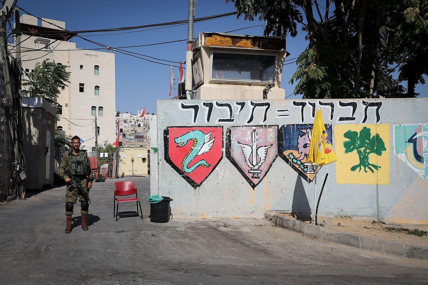 An Israeli soldier stands guard near an IDF base in the divided West Bank city of Hebron. September 4, 2019. (Photo by Gershon Elinson/Flash90)