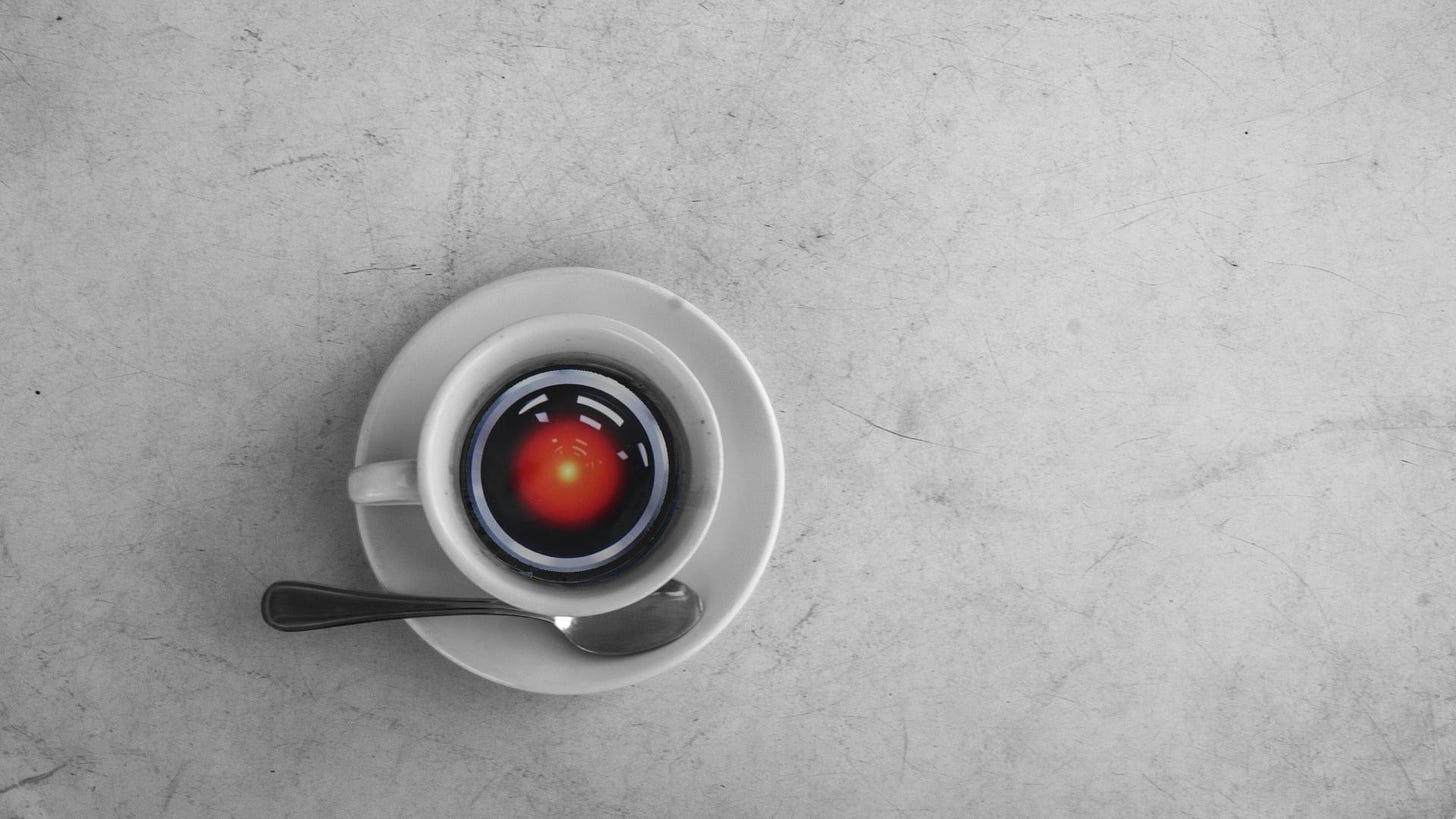 An espresso cup seen from above, overlaid with HAL from 2001: A Space Oddyssey