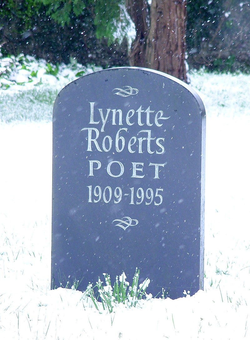 Dark grey headstone in a snowy churchyard which reads: Lynette Roberts / POET / 1909-1995