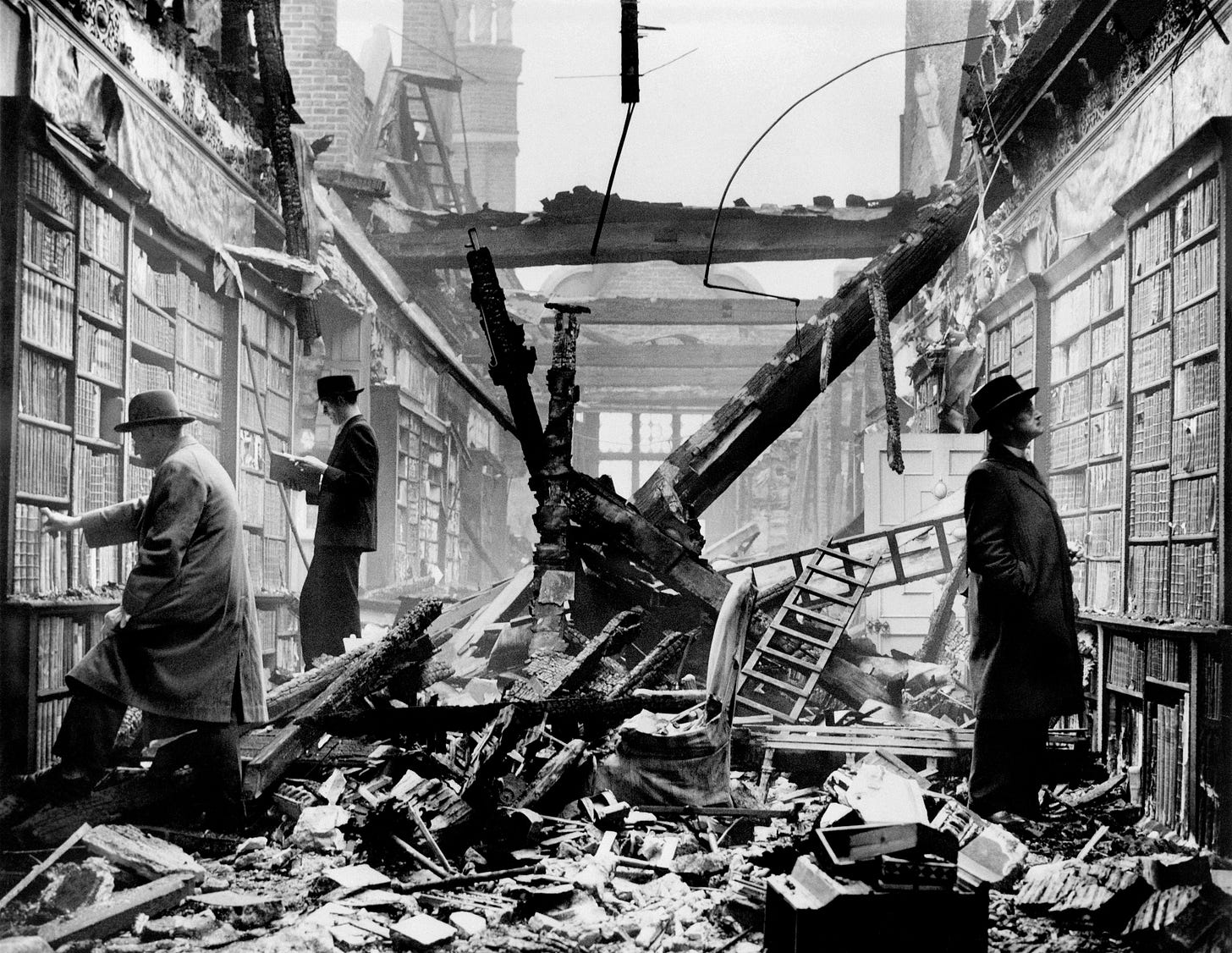 Black and white photo of 1940s men in hats browsing the bombed library of Holland House, London