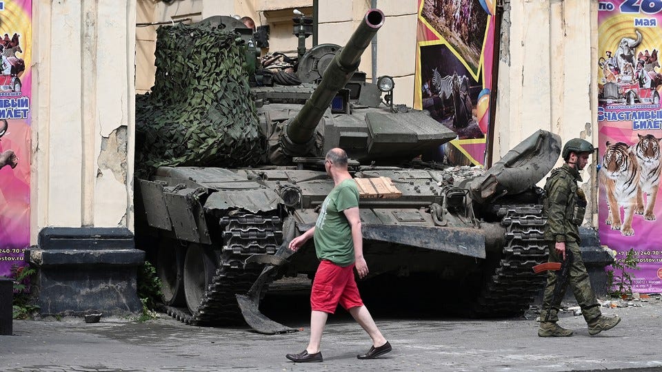 A civilian walks past a tank