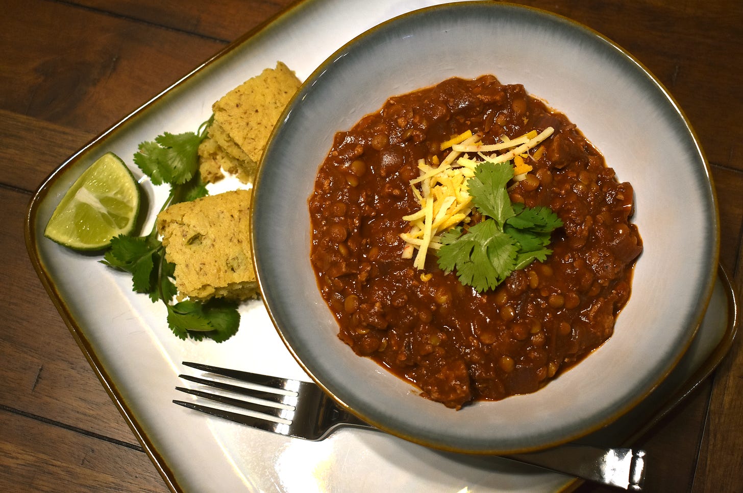 Vegan Tofu & Lentil Chili with Vegan Cornbread, cilantro and lime