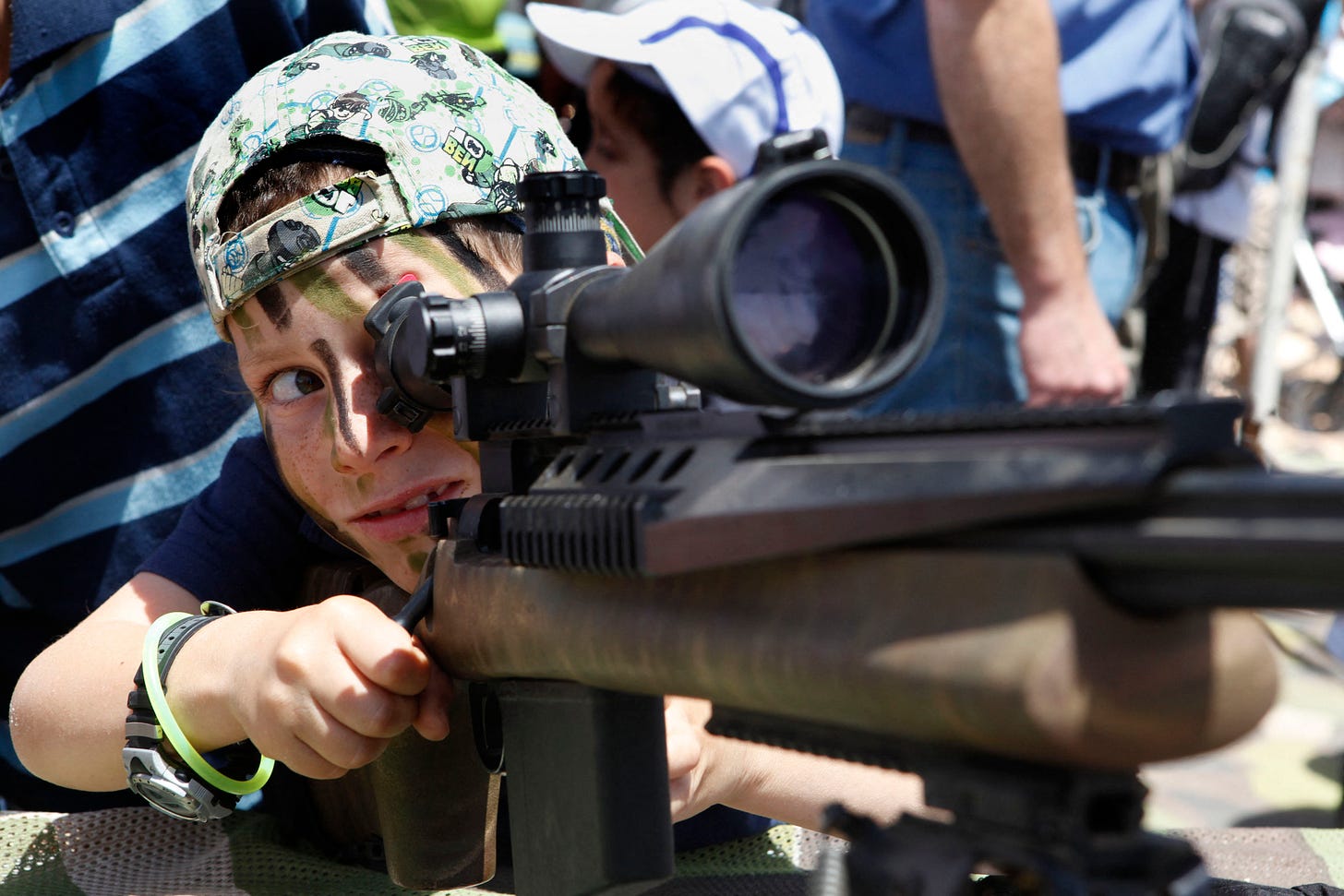 An Israeli boy playing with a rifle