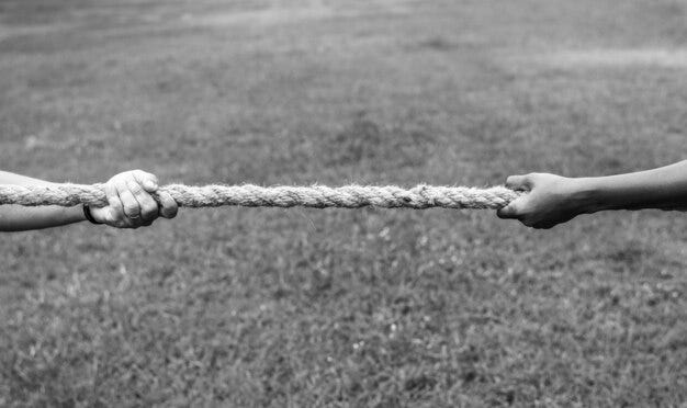 Free photo closeup of hand pulling the rope in tug of war game