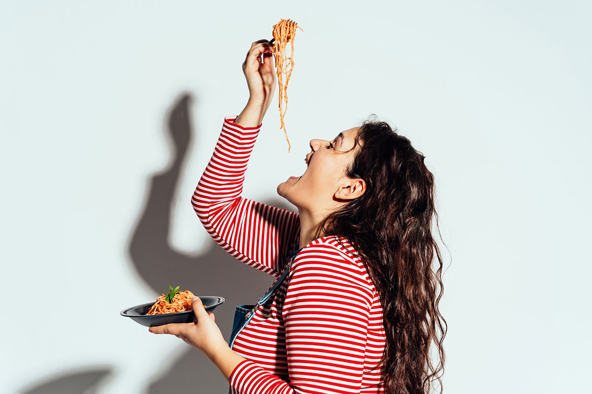 Woman honoring hunger by eating the damn pasta
